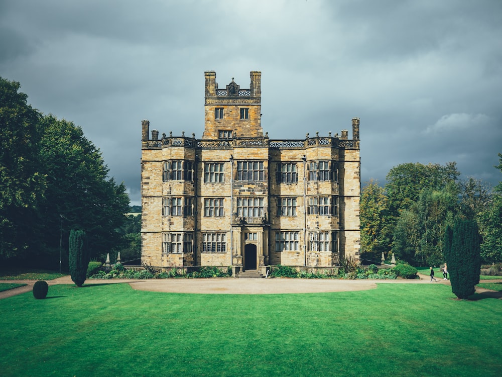 a large building sitting on top of a lush green field