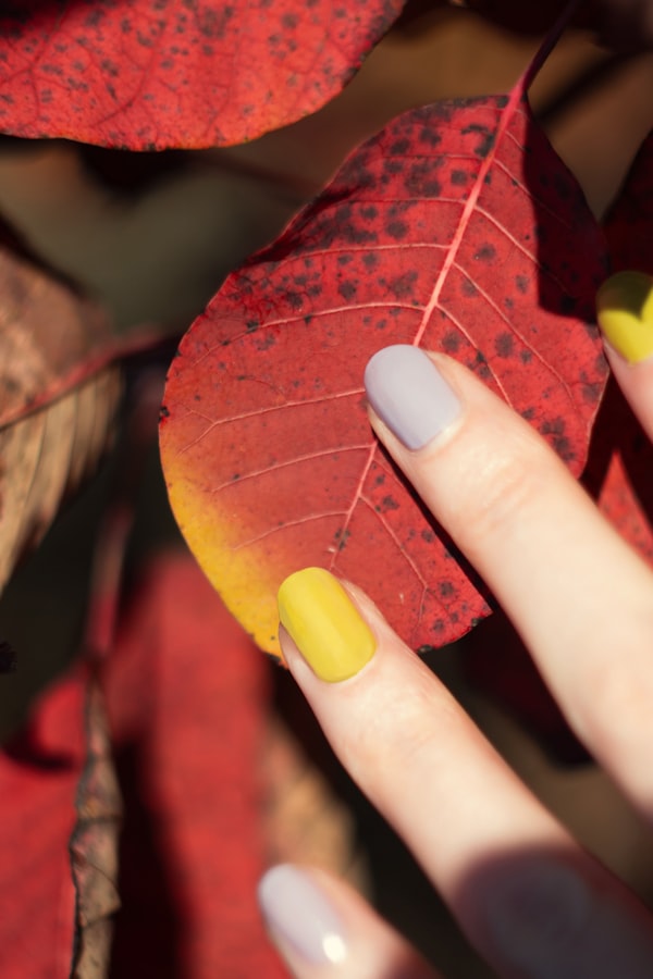 Witchy Galaxy — purple and yellow nails on autumn leaf