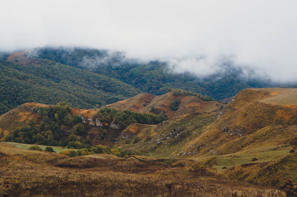 a view of a mountain range with clouds in the sky