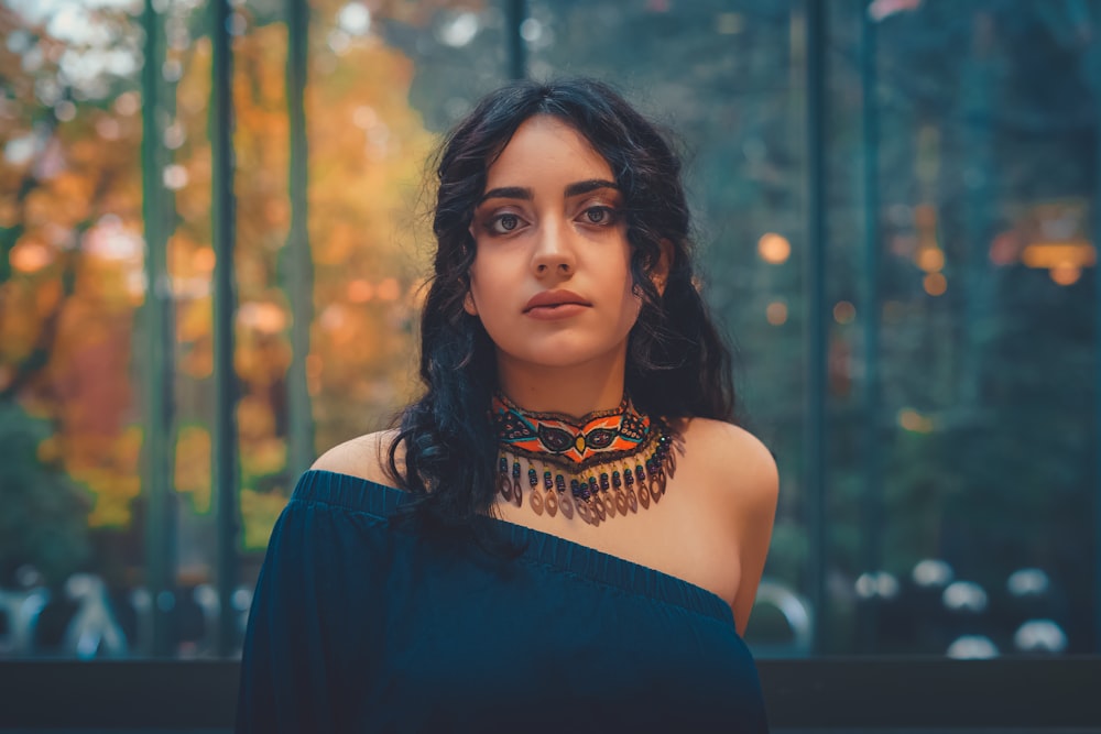 a woman wearing a black top and a necklace