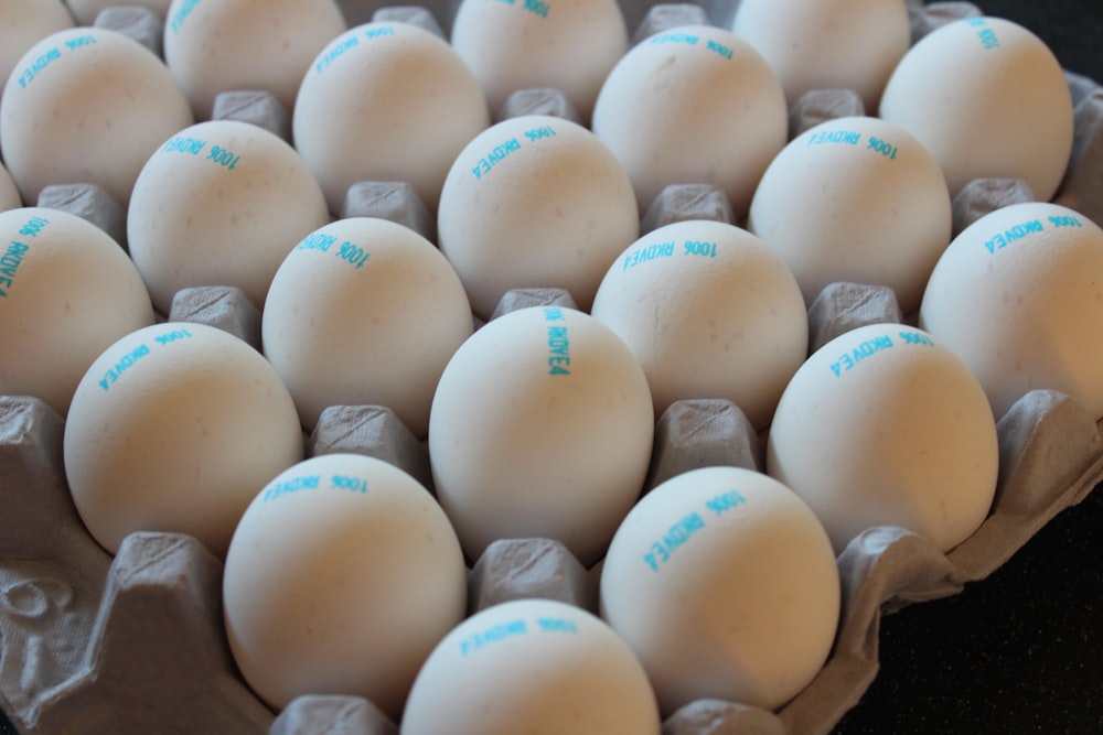 a carton filled with white eggs sitting on top of a counter