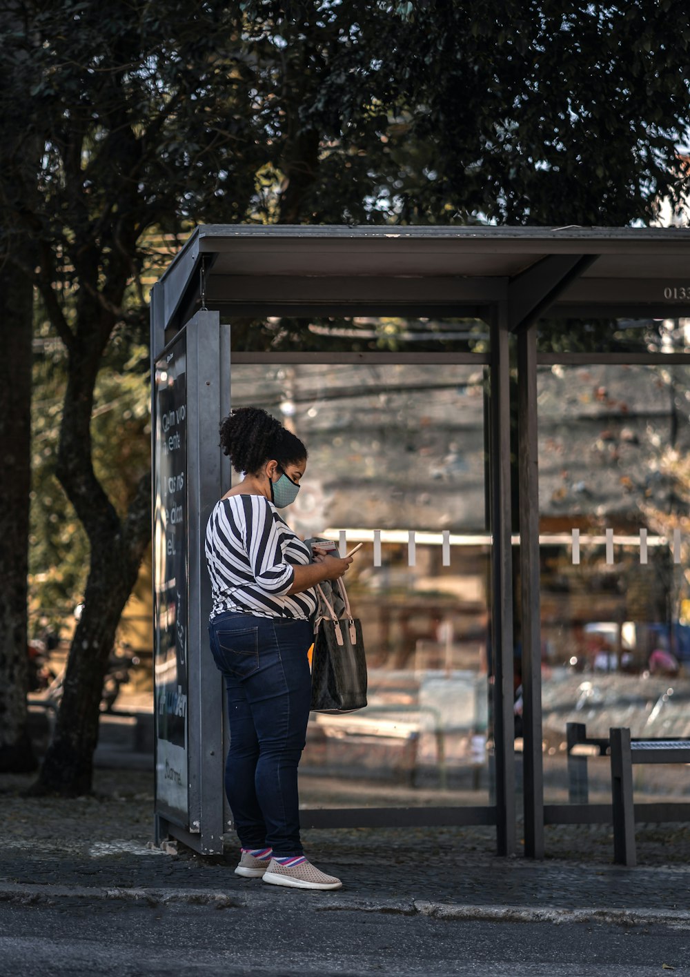 a woman standing in front of a bus stop