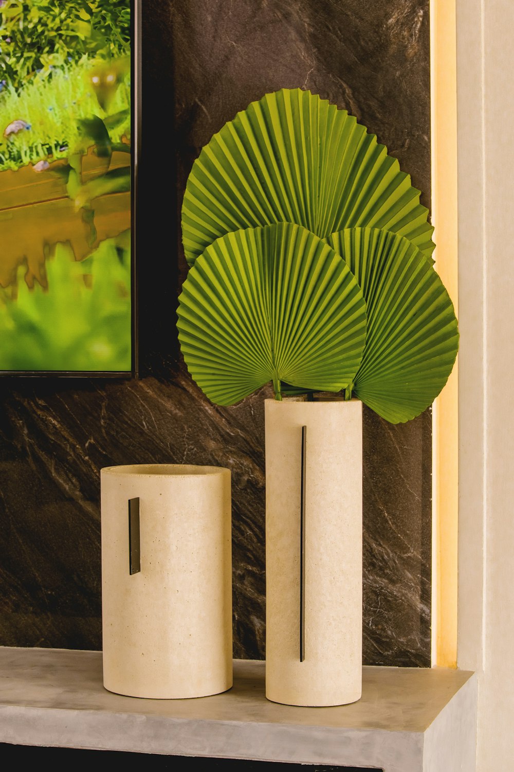 a couple of vases sitting on top of a mantle