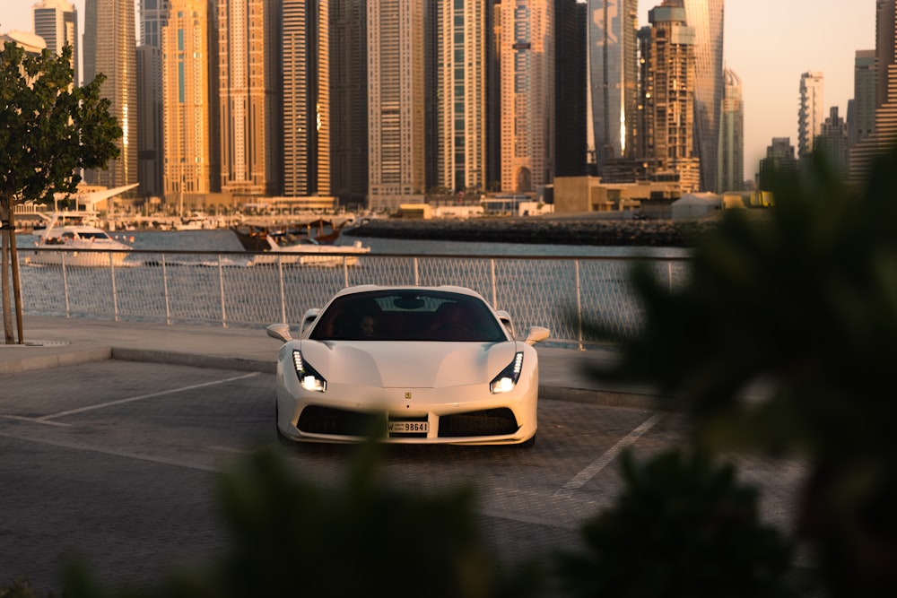 a white sports car parked in a parking lot