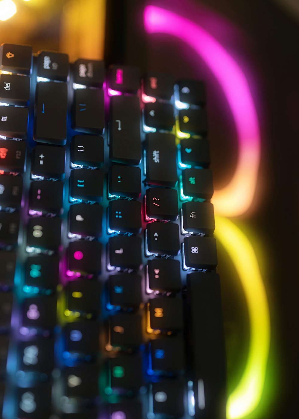 a close up of a keyboard with a multicolored background