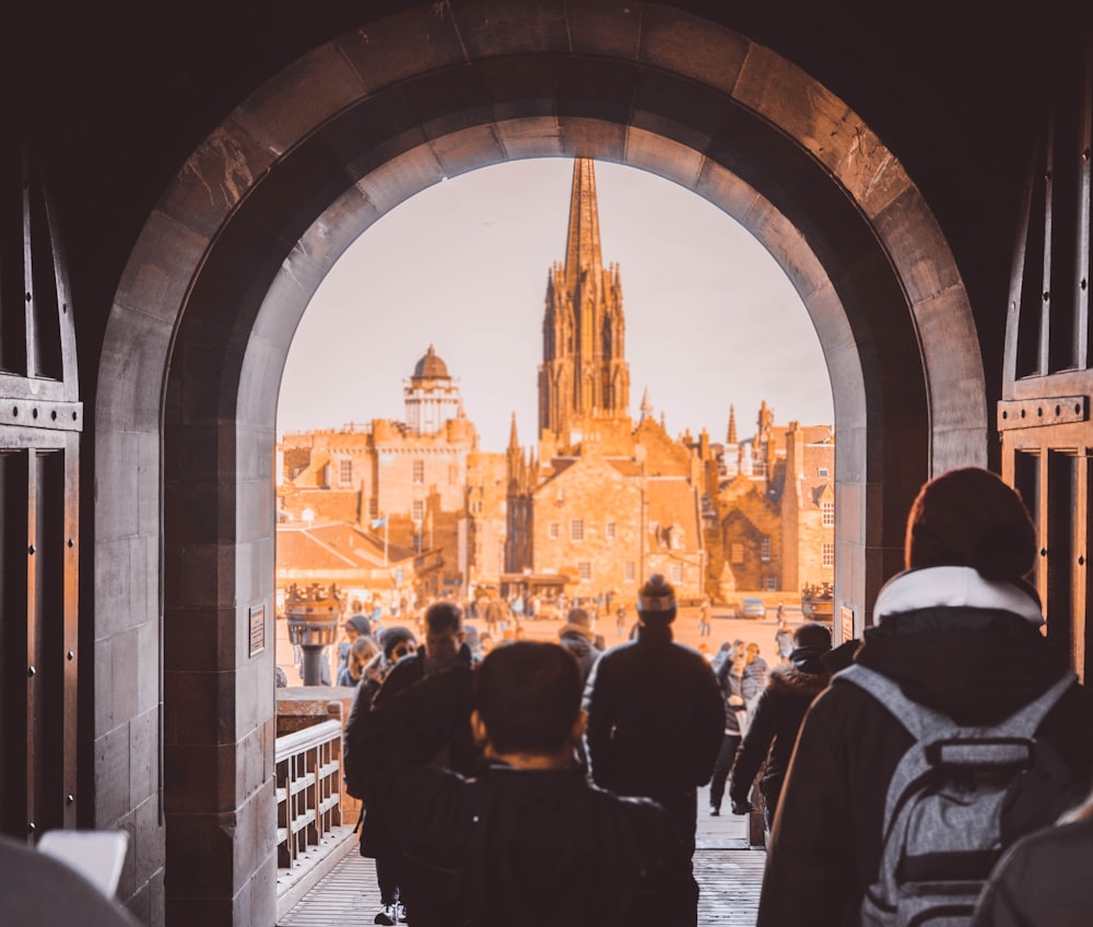 a group of people walking through a tunnel