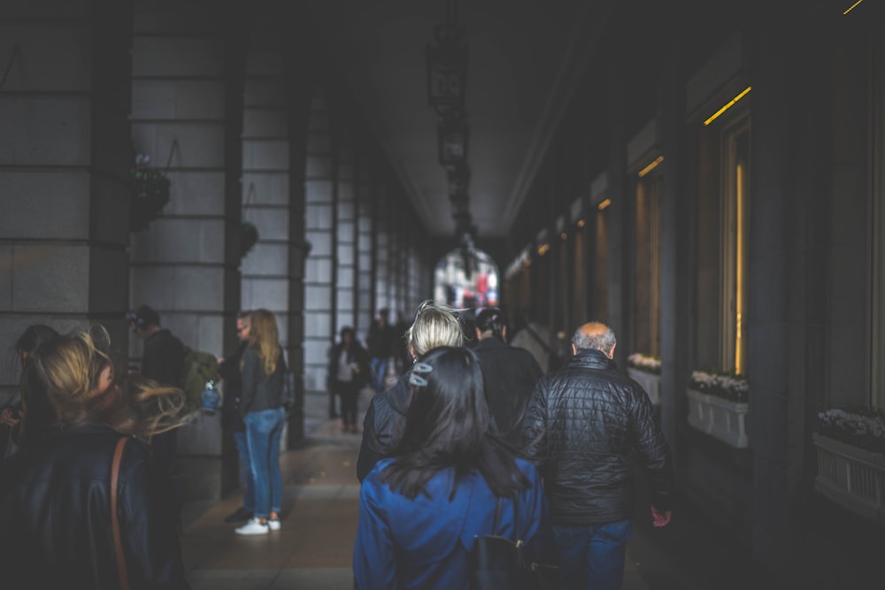 a group of people walking down a hallway