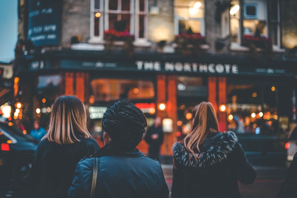 a group of people standing in front of a building