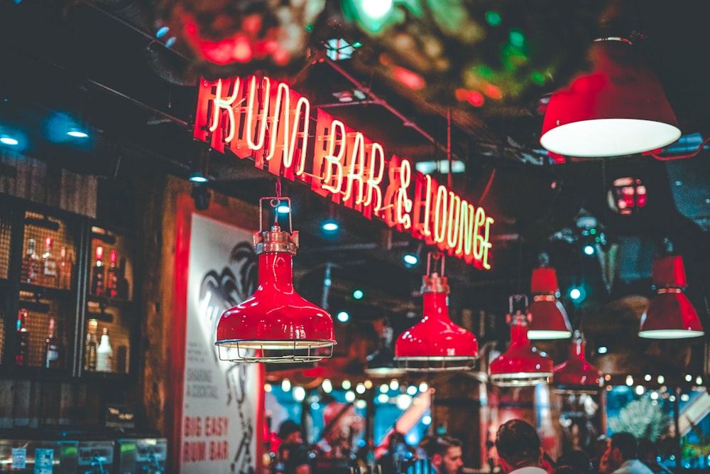 a restaurant with red lights hanging from the ceiling
