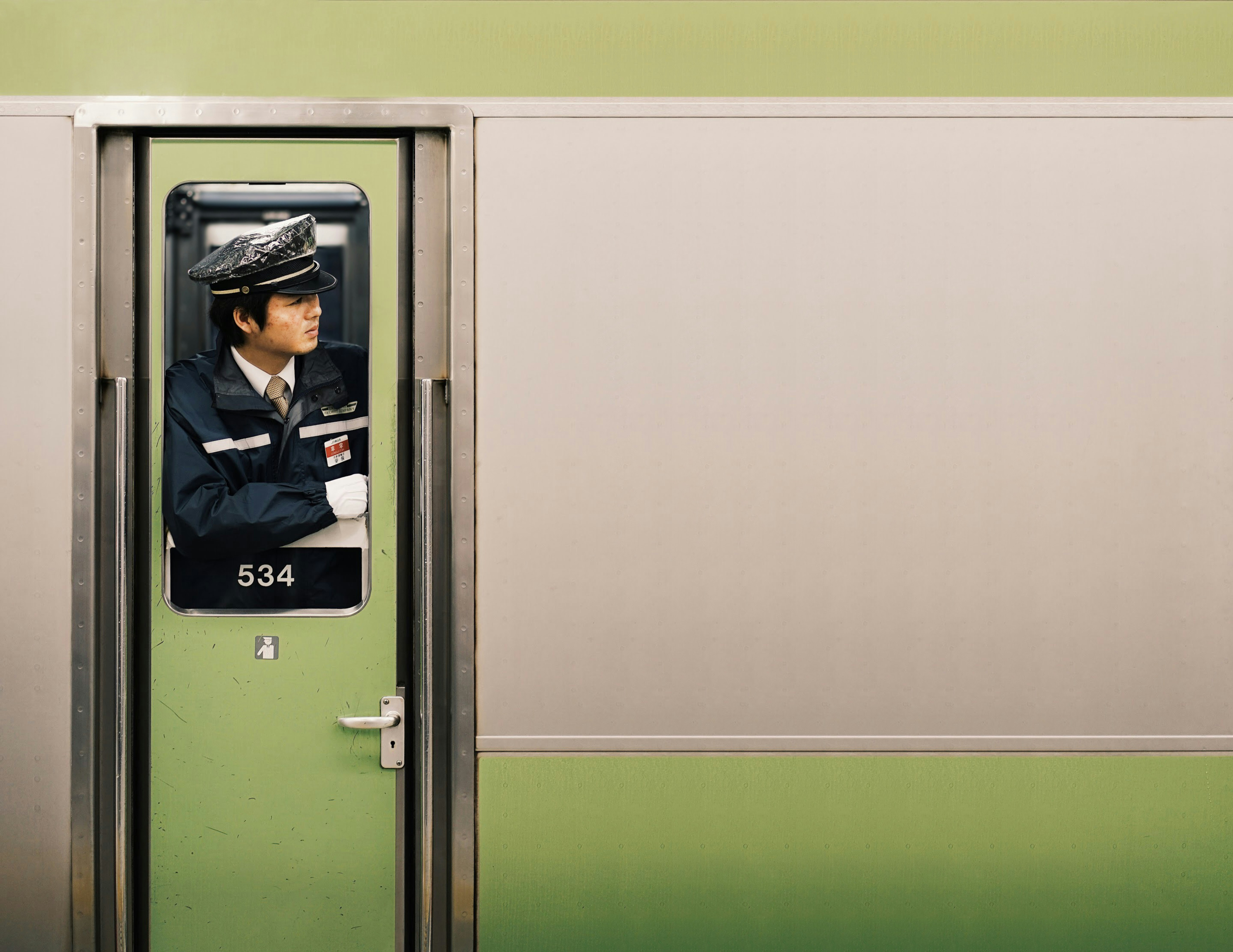 Person using a green Shinkansen ticket machine with English options visible