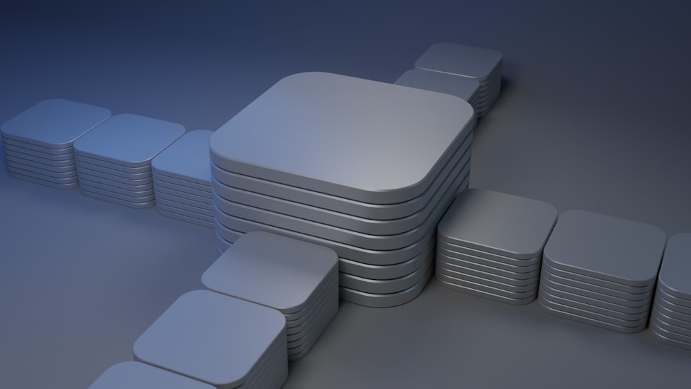 a stack of white square plates sitting on top of each other