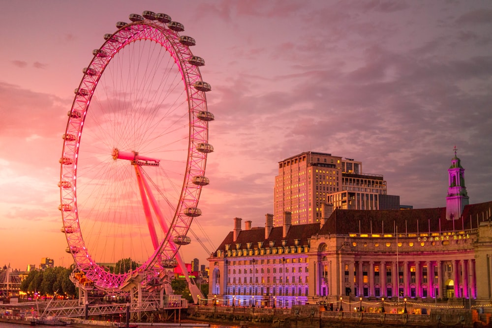 a large ferris wheel sitting next to a tall building