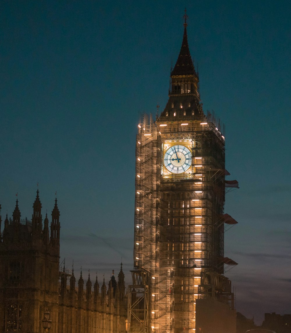 a large clock tower lit up at night