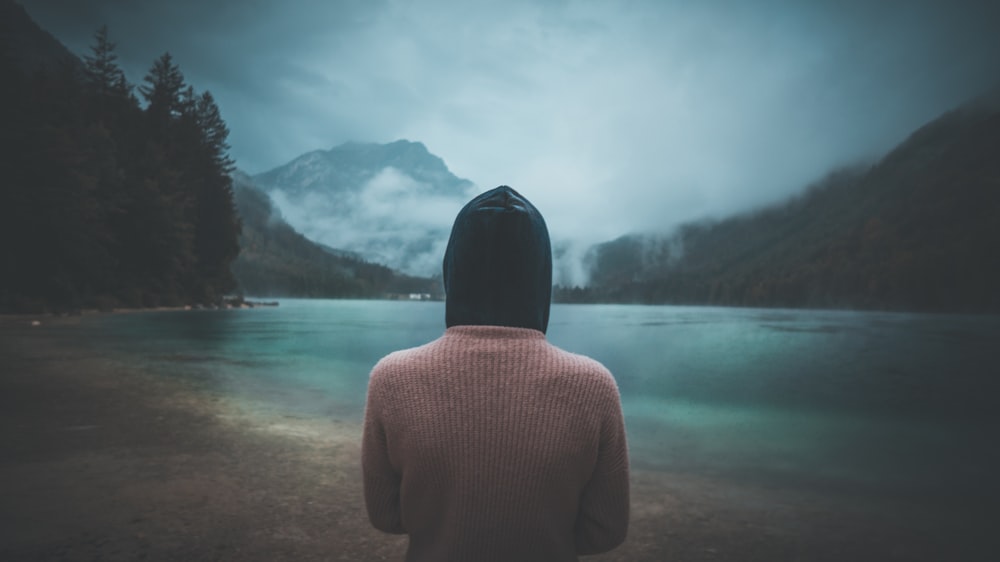 a person standing in front of a body of water