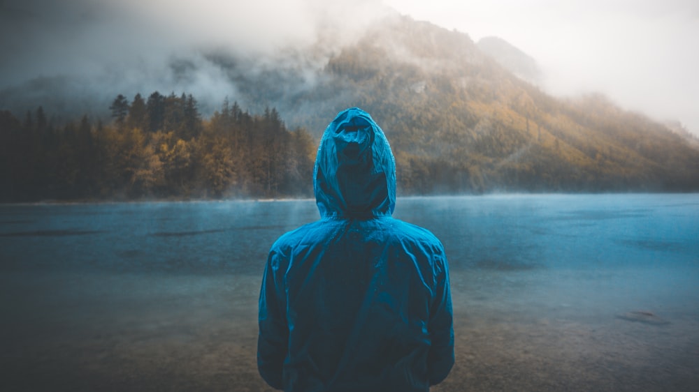 a person standing in front of a mountain