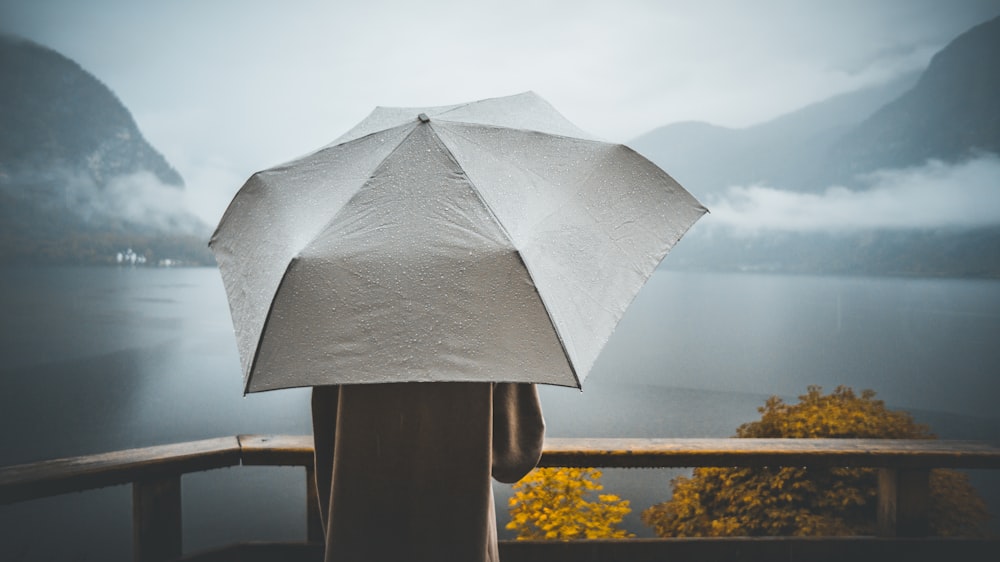 a person holding a white umbrella over their head