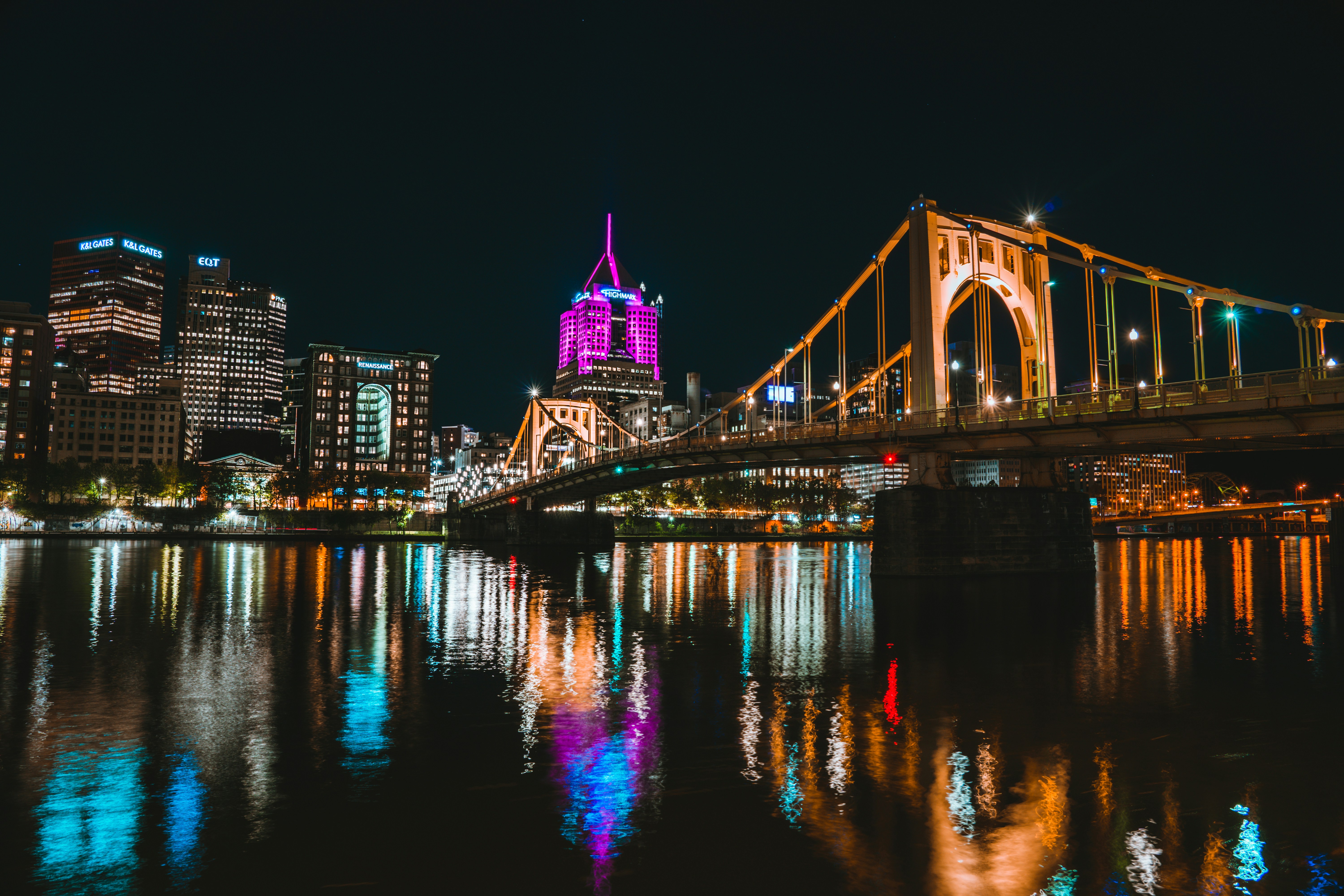 a large bridge over a river with a city in the background
