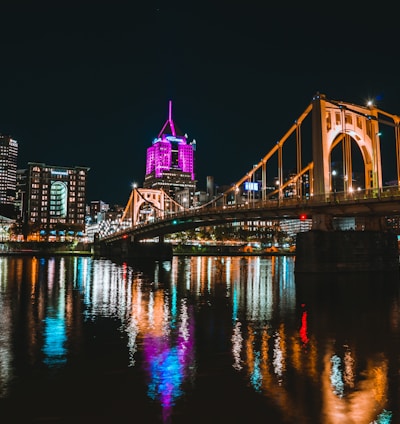 a large bridge over a river with a city in the background