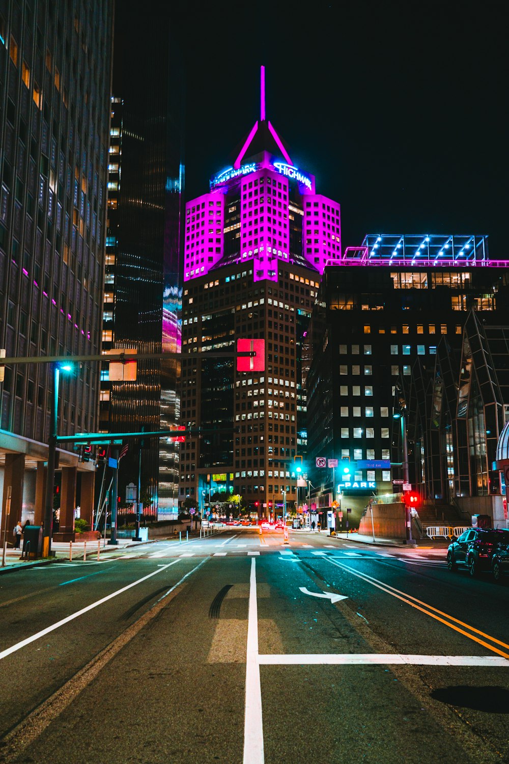 a city street at night with buildings lit up