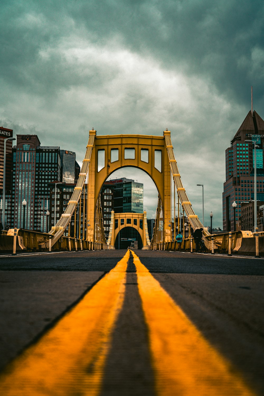 a yellow line on the road leading to a bridge