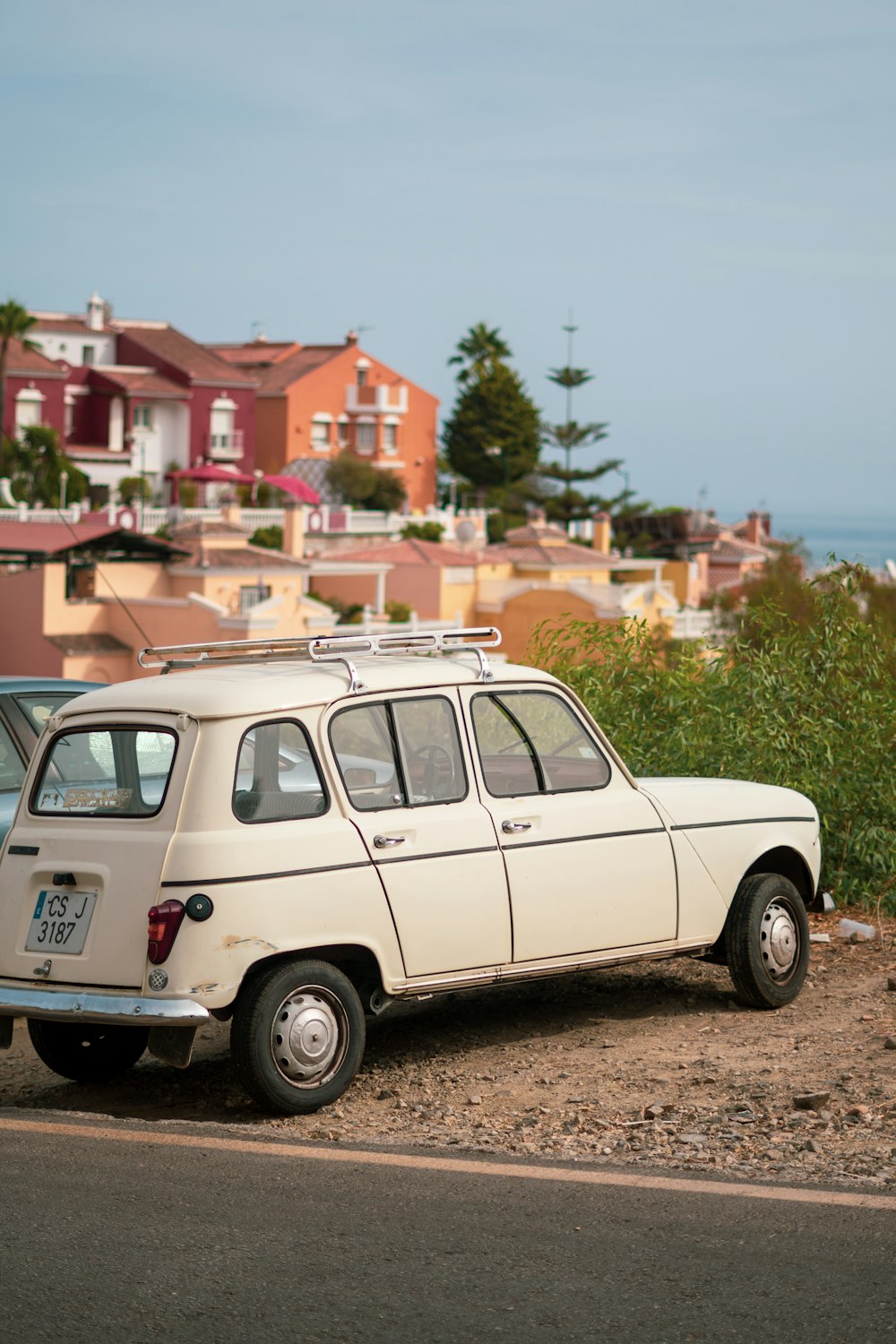 an old car parked on the side of the road