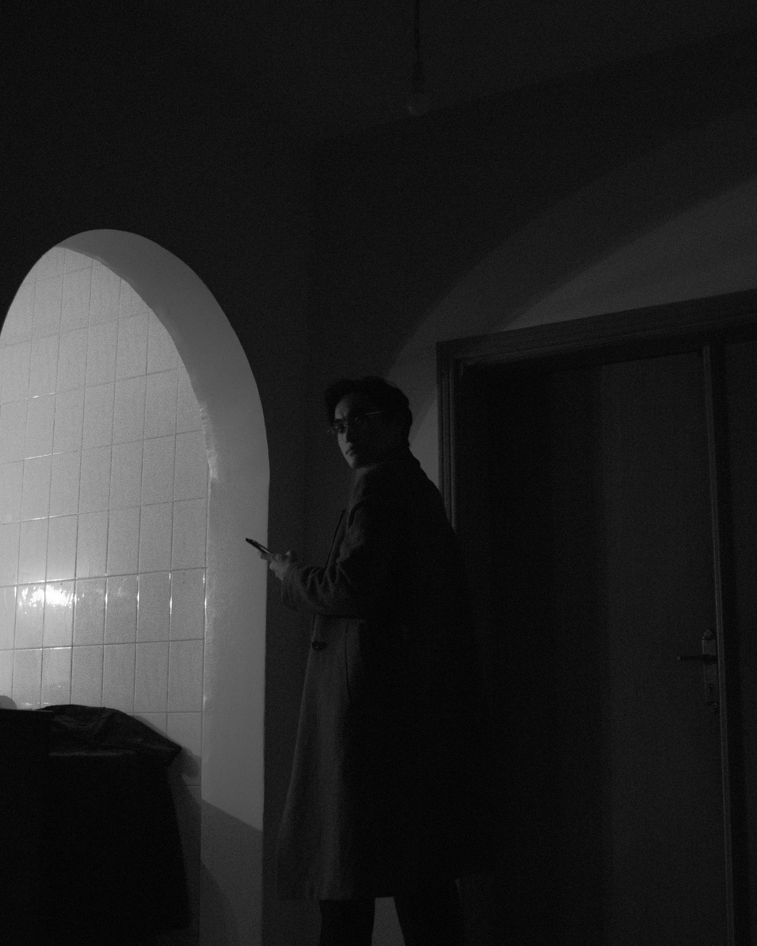 a man standing in front of a white wall