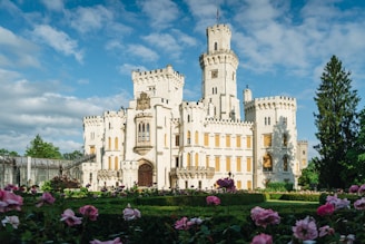 A serene garden with blooming flowers and a majestic castle in the background.