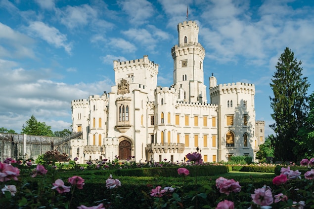 A serene garden with blooming flowers and a majestic castle in the background.