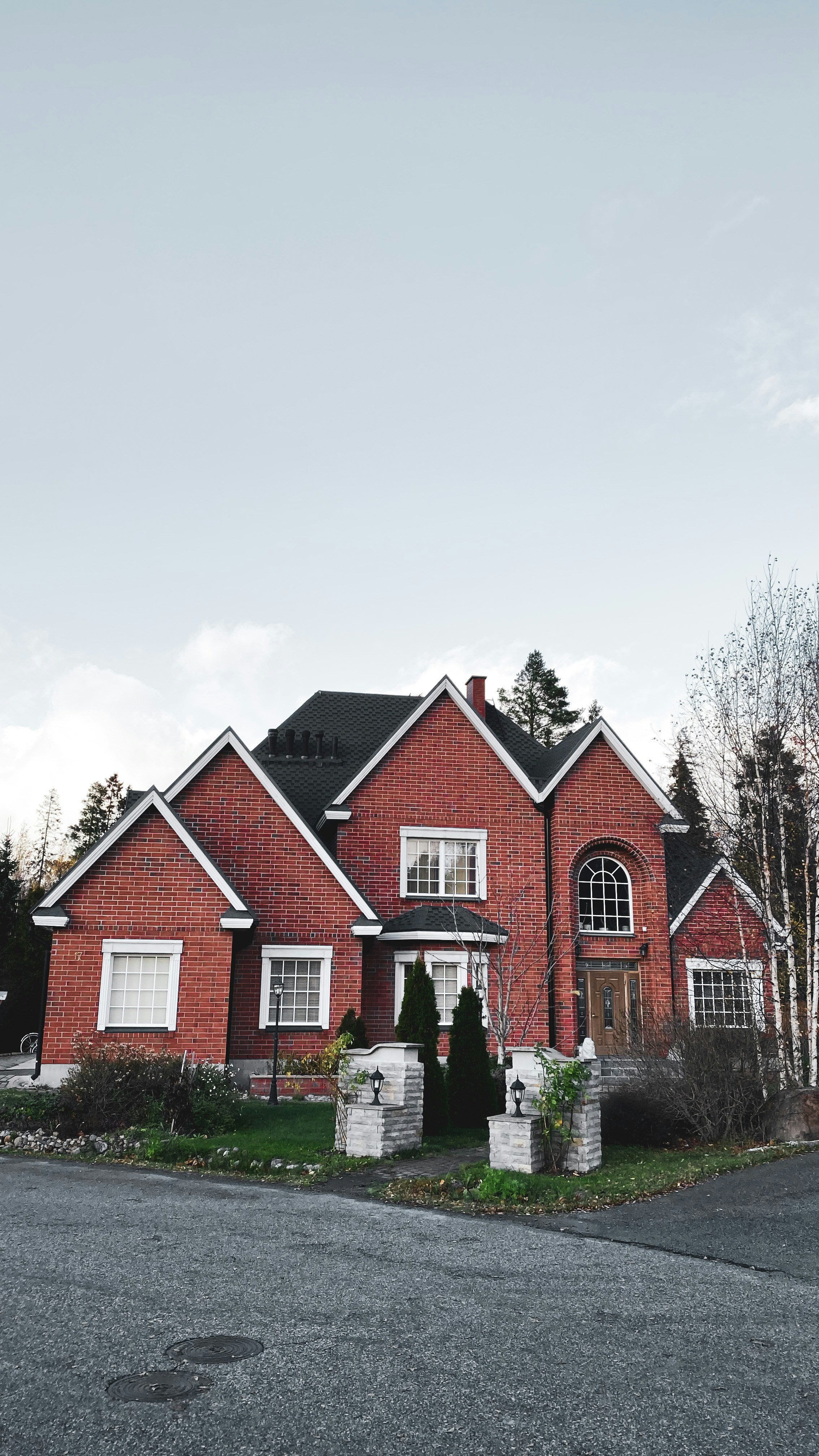 A red brick house with a black roof photo – Free Tree Image on Unsplash