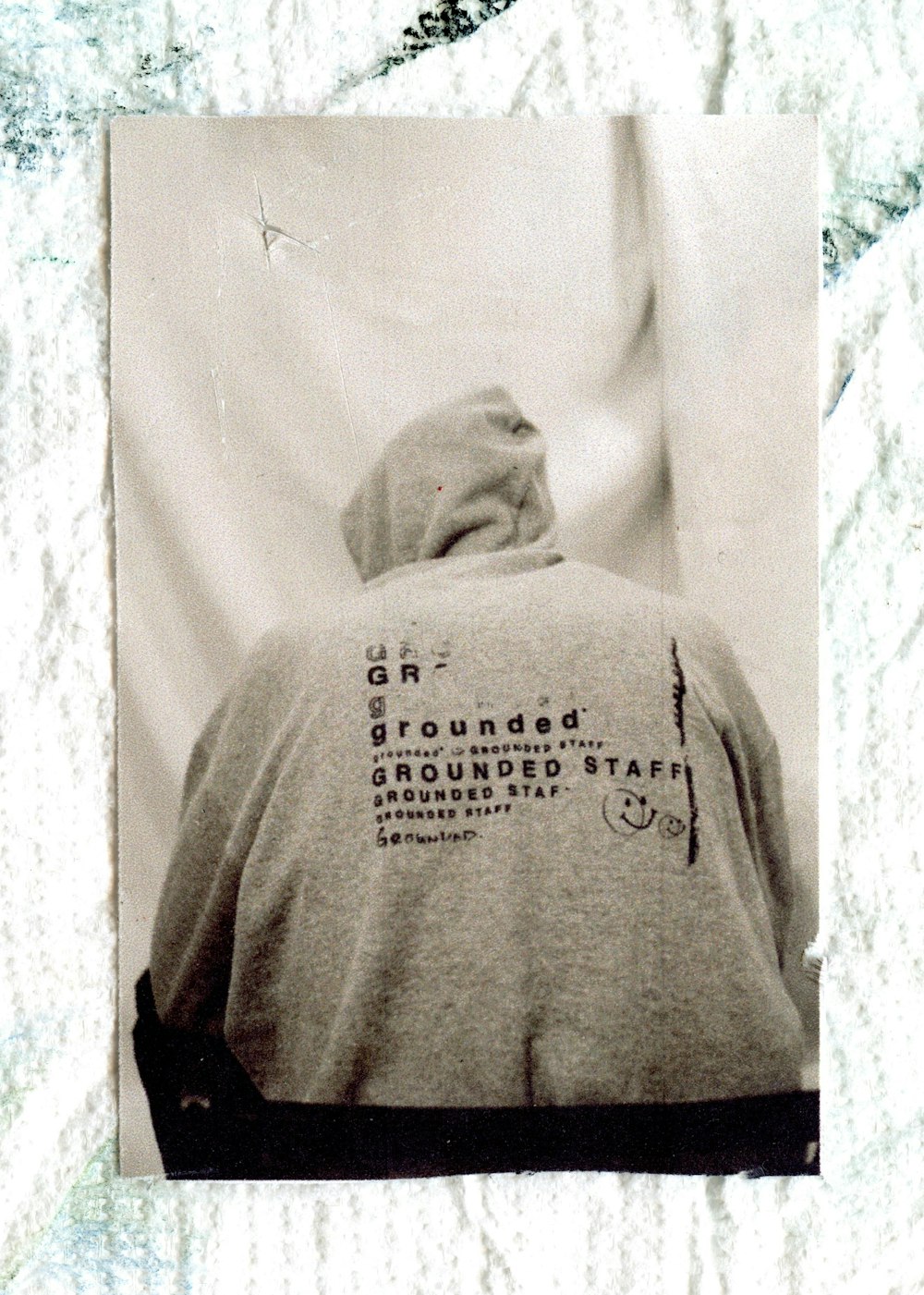 a black and white photo of a person wearing a hoodie