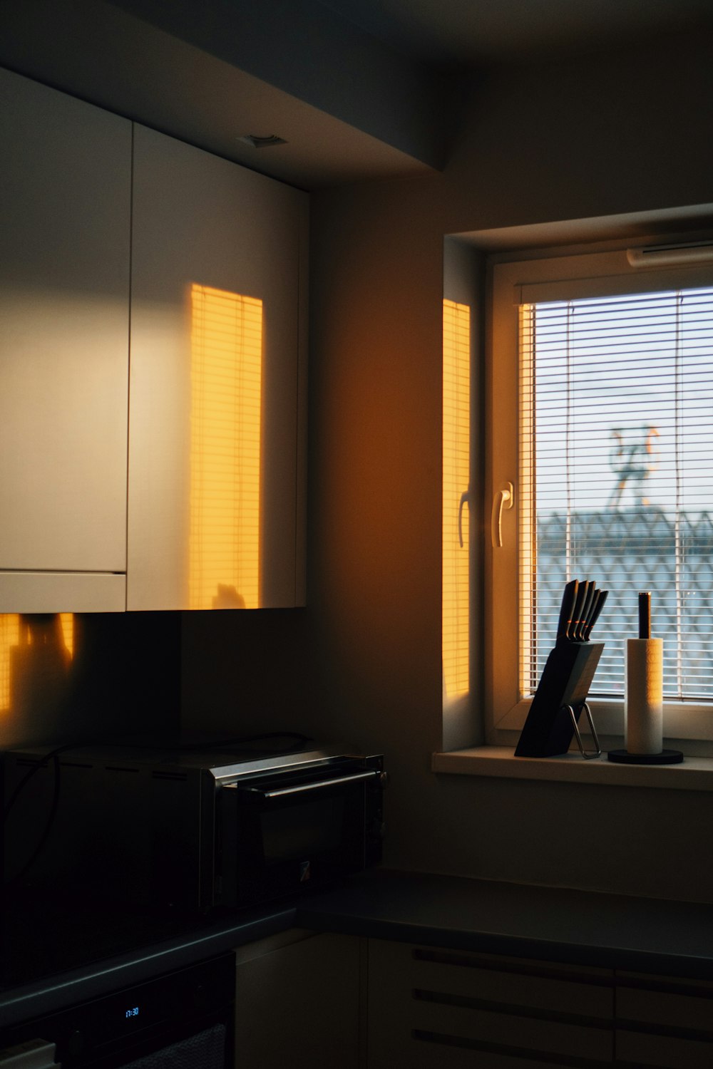 a kitchen with a window in a dark room