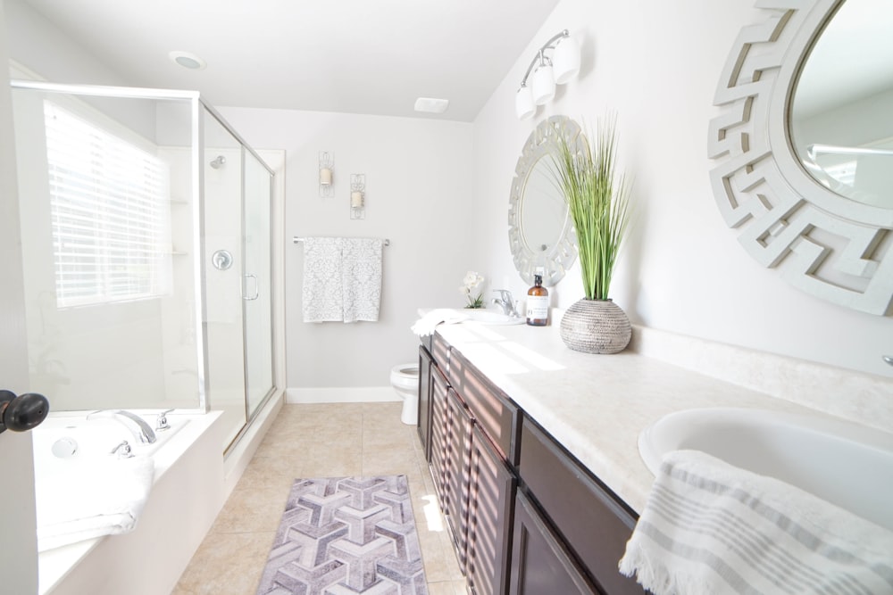 a bathroom with a sink, mirror, and bathtub