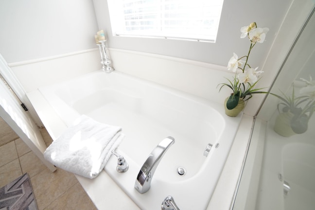 a white bath tub sitting next to a window