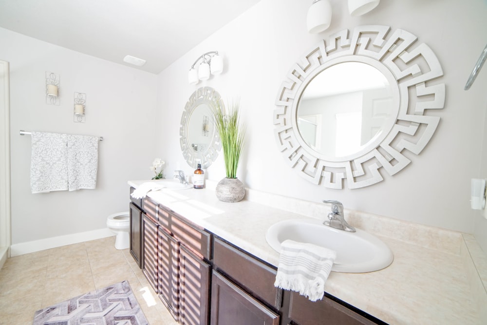 a bathroom with a large mirror and a sink