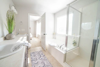 a bathroom with a tub, sink, and shower