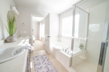 a bathroom with a tub, sink, and shower