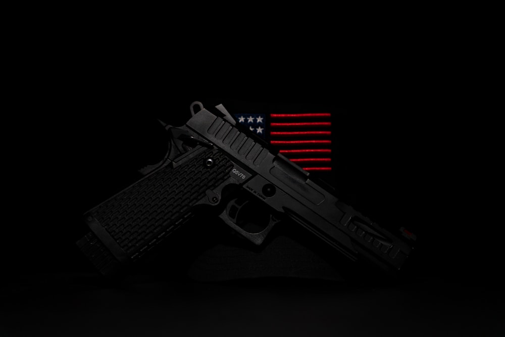 a gun with an american flag in the background