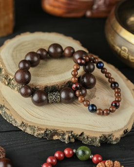 a couple of bracelets sitting on top of a wooden table