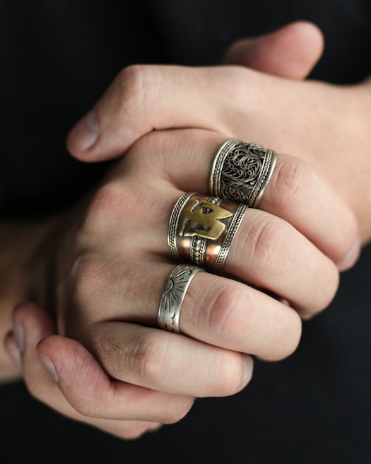 A hand adorned with multiple rings showcasing a stylish look.