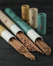A collection of beautifully packaged incense sticks arranged aesthetically on a wooden surface.