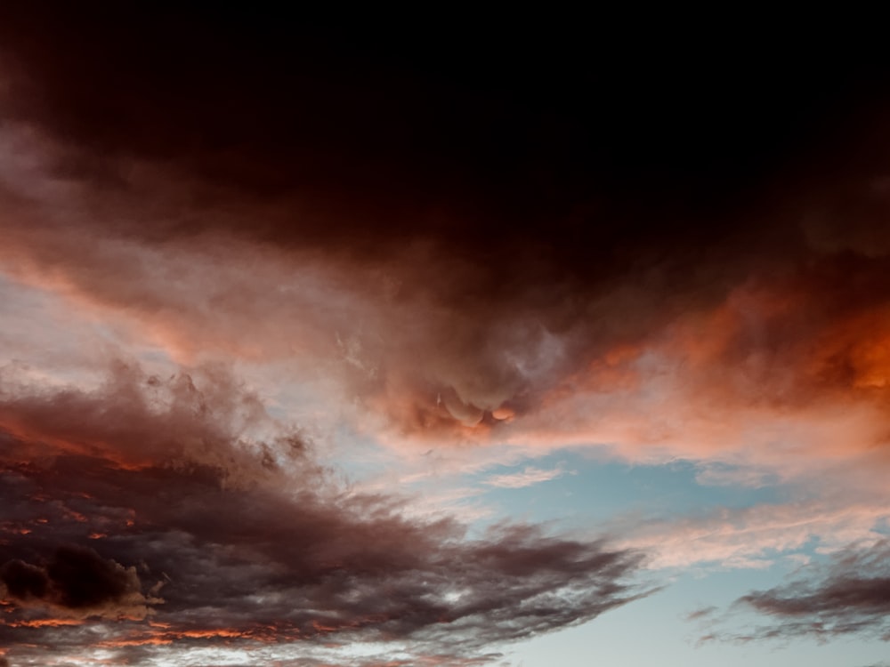 a plane flying in the sky with a lot of clouds