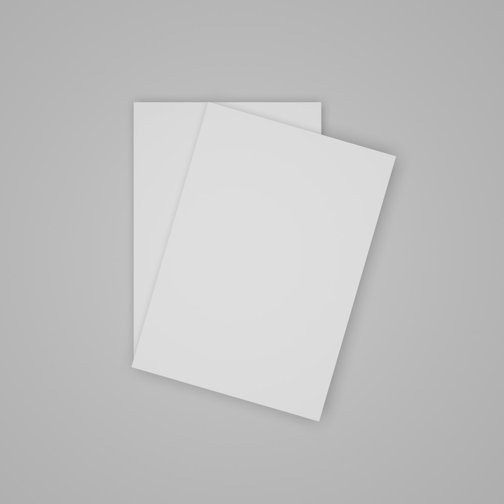 two white sheets of paper on a gray background