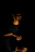 a man sitting in the dark holding a cell phone