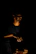 a man sitting in the dark holding a cell phone