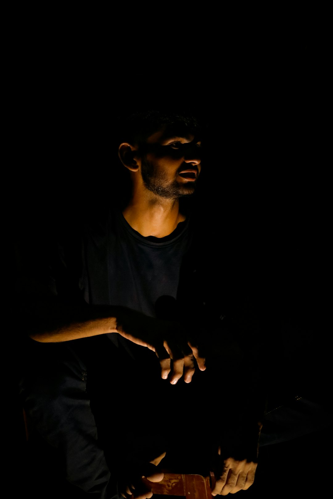vanda, medium, a man sitting in the dark holding a cell phone
