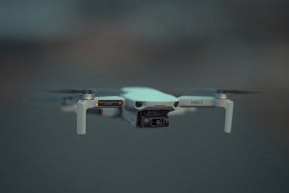 a camera attached to a small white and black object