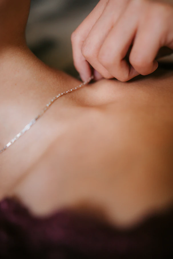 a close up of a person wearing a necklace