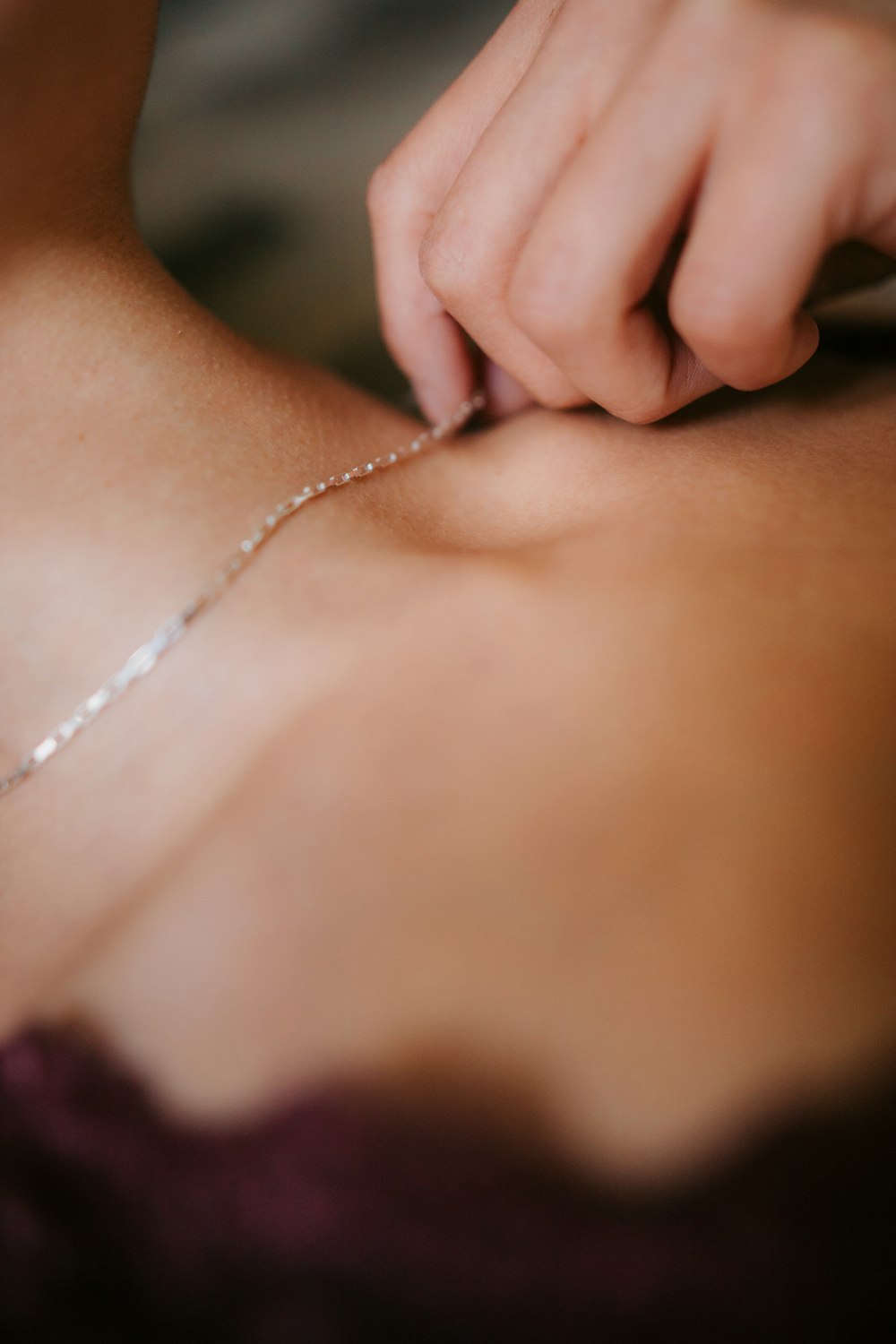 a close up of a person wearing a necklace