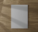 Custom paper orders displayed with natural textures and subtle shadows.