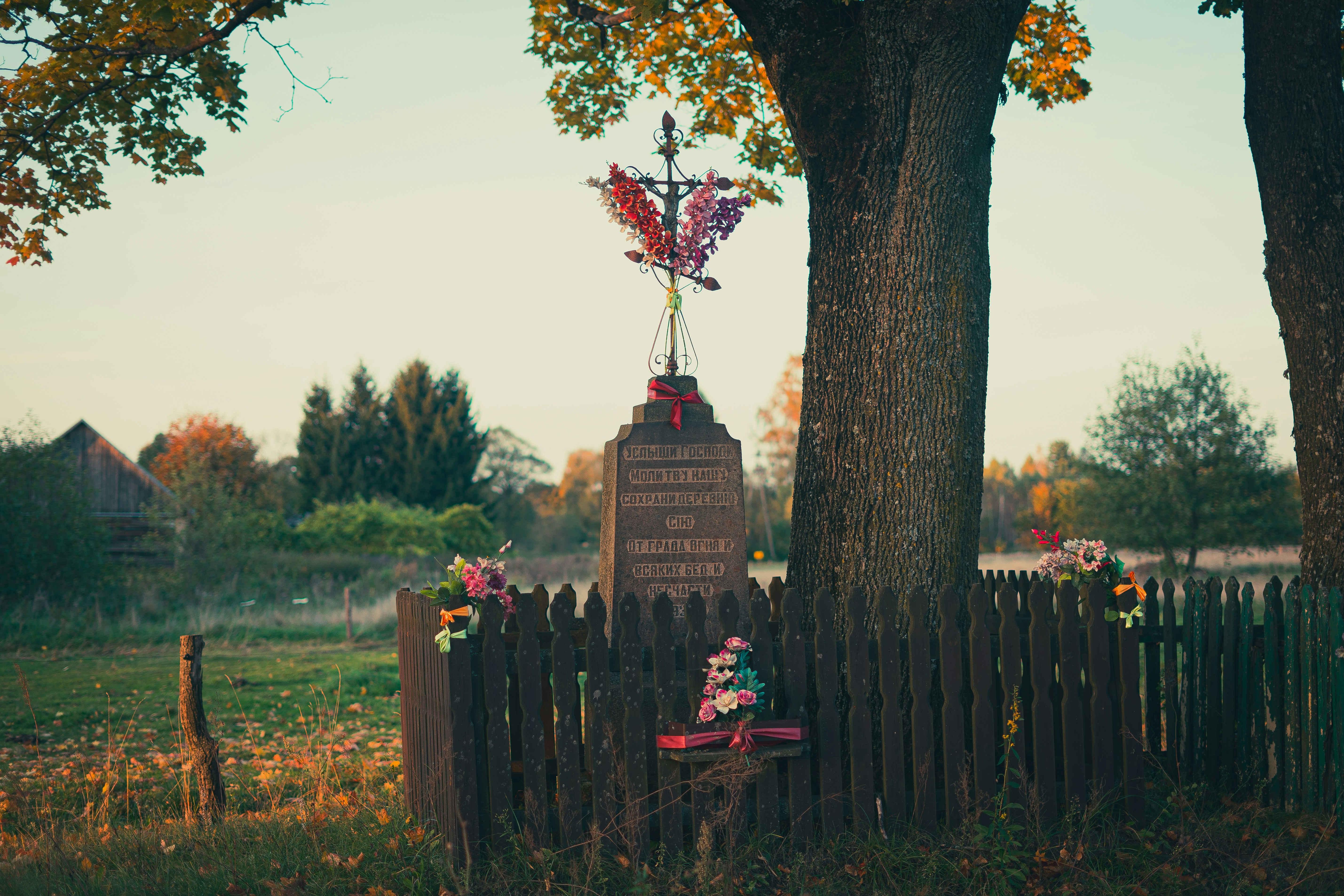 a wooden fence with a statue on top of it